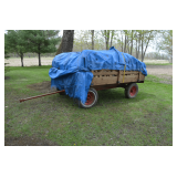flat bed wagon with side panels and full of split fire wood