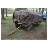 flat bed wagon with side panels and full of split fire wood