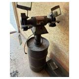 Bench grinder on concrete base