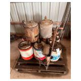 Pallet with vintage fuel cans and vintage seeder