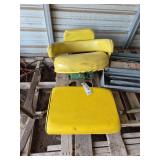 (2) John Deere tractor seats- (1) has bracket, bldg:green