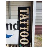 Large tattoo sign, bldg:green