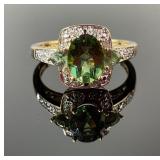 14K Gold Ring featuring Green and Clear Gemstones.