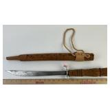 Ornate wood carved sword in sheath