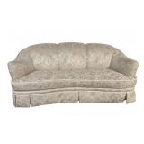 Cream colored upholstered sofa floral pattern