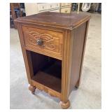 Small carved wood side table on casters