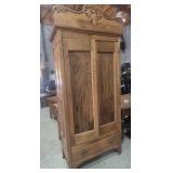 Walnut Armoire Featuring Decorative Carving At