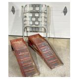 Red metal car ramps, lawn chair