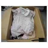 Box of doll and baby clothes