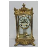 Ornate gilded mantle clock with beveled glass,