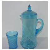 Blue carnival glass pitcher with lid and tumbler
