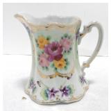 Porcelain pitcher with african violets