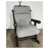 Wooden rocking chair with grey cushions