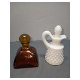 Fenton hobnail cruet alongside French amber glass