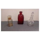 Two glass perfume bottles w glass stoppers . Ruby