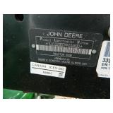 John Deere 1023E tractor with bucket and mower