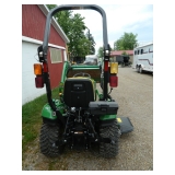John Deere 1023E tractor with bucket and mower