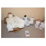 Variety of Vintage Porcelain/ceramic/bisque style Dolls - one in basket & 4 on stands