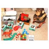 Variety of Vintage Kid Toys items: sewing machine, monkey, train etc.