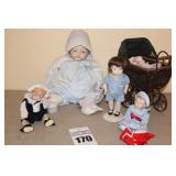 Variety of Bisque/Porcelain Dolls - one in carriage, one on stand etc.