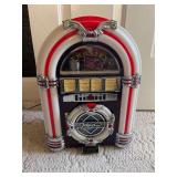 Crosley Mini Jukebox Portable Bluetooth Speaker, a Compact Audio Device Designed with a Retro Aesthetic.