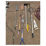 Trash Can with Rakes and Shovels