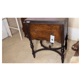 Antique sewing machine in wooden cabinet.