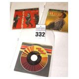 2 Vintage Elvis Presley 45s in original sleeves ("Shake Rattle and Roll/So Glad your mine" & "Moody Blue/She Thinks I Still Care") & additional 45 stored in sleeve