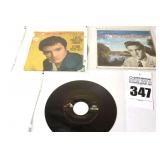 2 Vintage Elvis Presley 45s in original sleeves ("Peace In the Vally/I Need your Love Tonight" & "Blue Christmas/Santa Clause is Back in Town") & additional 45 stored in sleeve