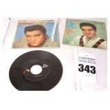 2 Vintage Elvis Presley 45s in original sleeves ("US Male/Stay Away" & "Loving You/Wear My Ring Around your Neck") & additional 45 stored in sleeve