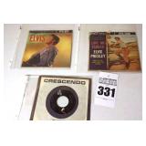 2 Vintage Elvis Presley 45s in original sleeves ("Love Me Tender/Rip It Up" & "Everyday was like Christmas/How would you Like to Be") & additional 45 stored in sleeve