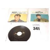 2 Vintage Elvis Presley 45s in original sleeves ("Long Legged Girl/It Feels so Right" & "I Believe in the Man in the Sky/Crying In the Chapel") & additional 45 stored in sleeve