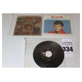 2 Vintage Elvis Presley 45s in original sleeves ("I Want you and I need You, I Love you/My Baby Left Me" & "Indescribable Blue/Christmas Sings") & additional 45 stored in sleeve