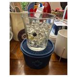 Clear Glass Tumbler Filled with Marbles and Blue Storage Container