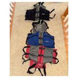 Three life vests, personal flotation devices