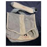 Large pole, fishing satchel by fishpond