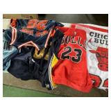 Lot of basketball shirts, shorts, and 1 flag