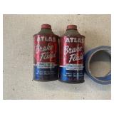 Two Atlas Brake fluid cans