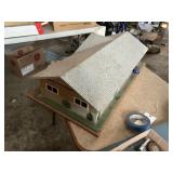 Metal doll house, mounted to wooden base, plastic