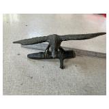 Small metal bird on branch