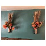 2 wall sconces with floral arrangements