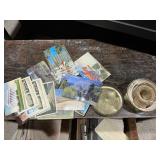 Vintage postcards and a tin with what appears to