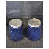 Blue glass jars with metal lids.