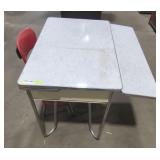 Metal table with red metal chair.