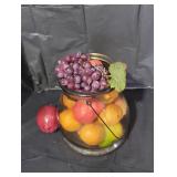 Glass jar with metal handle and fake fruit inside.