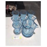 Blue glass pitcher with 7 matching cups.