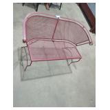 Maroon metal patio bench.