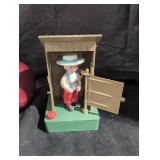 The outhouse figurine.