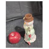 Glazed over ceramic snowman figurine.