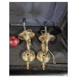 Brass electric wall scones with lamp shades.
